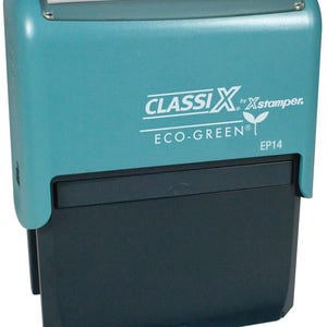 May include: A teal blue self-inking stamp with the text "CLASSIX by Xstamper. ECO-GREEN® EP14" in white.