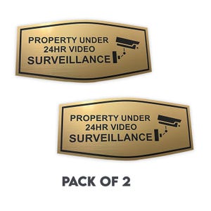 Property Under 24 Hour Video Surveillance Sign – Pack of 2, 9 x 4.5 Inches, Durable Plastic Laminate with Camera Image, Silver & Gold Colors