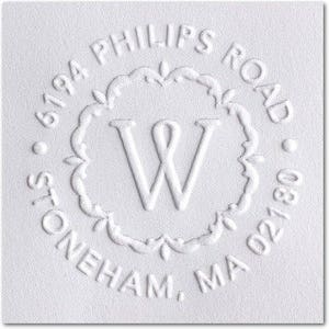 May include: White round return address stamp with the text "6194 Phillips Road Stoneham, MA 02180" and a decorative border with the letter "W" in the center.