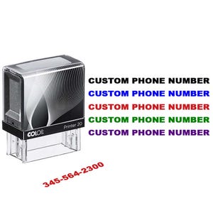May include: A clear and black self-inking stamp with the text "Printer 20" and the brand "COLOP". The stamp is next to the text "CUSTOM PHONE NUMBER" in various colors and the phone number "345-564-2300".