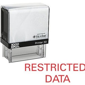 May include: A black and white self-inking stamp with the text "RESTRICTED DATA" in red letters. The stamp is labeled "Printer 20" and has a Microban logo.