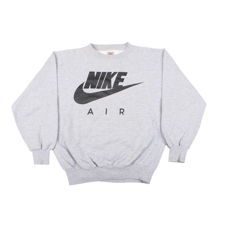 Vintage Nike Air gray crewneck sweatshirt with large Nike Swoosh logo in classic 1990s style.