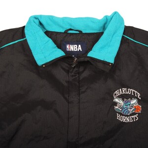 black teal jacket , nylon jacket , retro clothing , throwback jacket , collectors nba , starter style jacket , teal windbreaker , charlotte hornets gear , nba apparel vintage , vintage outerwear , basketball fan gear , xl streetwear , retro sports fan , mens retro style , nba team jacket , oversized windbreaker , 1990s fashion , usa retro vintage , fan merchandise , sports memorabilia , hip hop vintage , y2k streetwear , zip up jacket , trendy vintage , classic nba merch