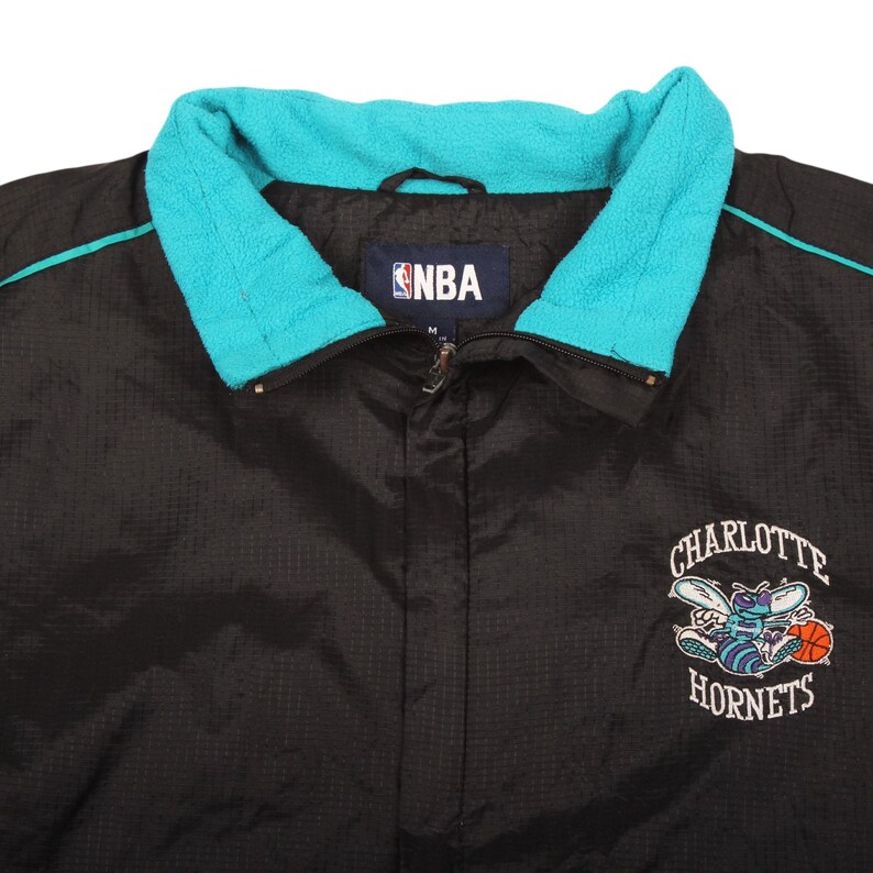 black teal jacket , nylon jacket , retro clothing , throwback jacket , collectors nba , starter style jacket , teal windbreaker , charlotte hornets gear , nba apparel vintage , vintage outerwear , basketball fan gear , xl streetwear , retro sports fan , mens retro style , nba team jacket , oversized windbreaker , 1990s fashion , usa retro vintage , fan merchandise , sports memorabilia , hip hop vintage , y2k streetwear , zip up jacket , trendy vintage , classic nba merch