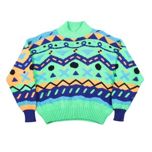May include: A long-sleeve knit sweater featuring a vibrant geometric pattern in shades of bright green, royal blue, light blue, and peach. The design includes horizontal bands of zigzags, circles, and cross shapes, with a ribbed mock neck and cuffs.