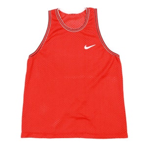 May include: Red mesh basketball jersey with a white Nike swoosh logo.