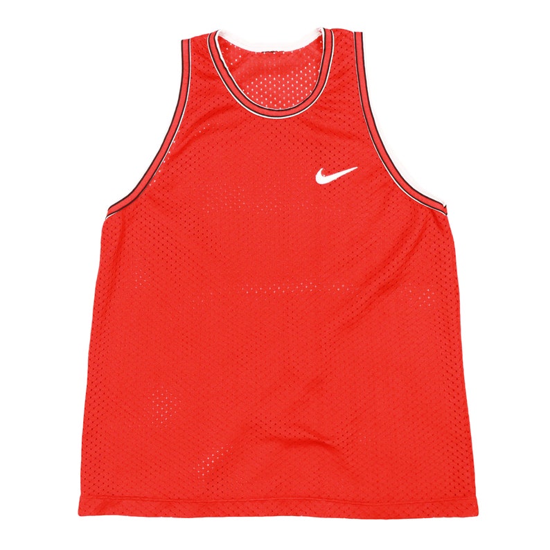 May include: Red mesh basketball jersey with a white Nike swoosh logo.