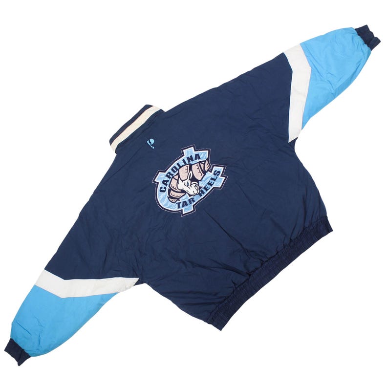 sports fan jacket , unc outfit , college gear vintage , north carolina apparel , retro sports jacket , mens daily jacket , trendy sportswear , college aesthetic , vintage ncaa clothing , unc logo jacket , college football jacket , basketball fan jacket , sports fashion jacket , ncaa streetwear , mens blue jacket , zip up jacket , college style jacket , fan apparel vintage , throwback college jacket , sports team jacket , urban streetwear , ncaa outfit , vintage team jacket