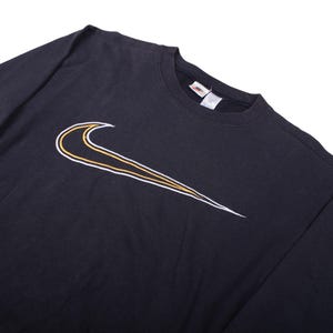 vintage Nike swoosh black sweatshirt , Oversized Nike crewneck sweatshirt flat lay , Classic 90s Nike sweatshirt with big swoosh logo , Black Nike pullover crewneck retro streetwear , Vintage Nike sportswear sweatshirt front side , Retro Nike swoosh jumper laid flat , 90s Nike oversized sweatshirt with logo print , Black Nike crewneck sweater vintage style , Unisex retro Nike sweatshirt streetwear look , Vintage Nike swoosh sweatshirt for men women