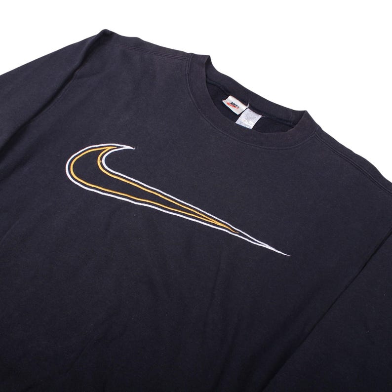 vintage Nike swoosh black sweatshirt , Oversized Nike crewneck sweatshirt flat lay , Classic 90s Nike sweatshirt with big swoosh logo , Black Nike pullover crewneck retro streetwear , Vintage Nike sportswear sweatshirt front side , Retro Nike swoosh jumper laid flat , 90s Nike oversized sweatshirt with logo print , Black Nike crewneck sweater vintage style , Unisex retro Nike sweatshirt streetwear look , Vintage Nike swoosh sweatshirt for men women