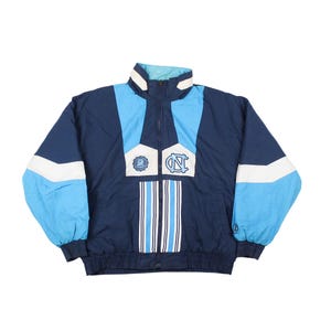 Vintage North Carolina Tar Heels jacket blue with UNC logo front and large Carolina Tar Heels graphic on back, 90s NCAA college windbreaker jacket