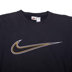 black vintage nike oversized sweater , 90s nike sportswear swoosh sweatshirt , nike vintage streetwear crewneck pullover , 	vintage nike sweatshirt , nike crewneck , nike swoosh sweatshirt , black nike sweater , 90s nike sweatshirt , y2k nike sweater , retro nike jumper , vintage nike clothing , nike sportswear sweatshirt , unisex nike crewneck , oversized nike sweatshirt , nike retro pullover , vintage nike swoosh logo , nike logo sweatshirt , 90s nike pullover , vintage streetwear nike