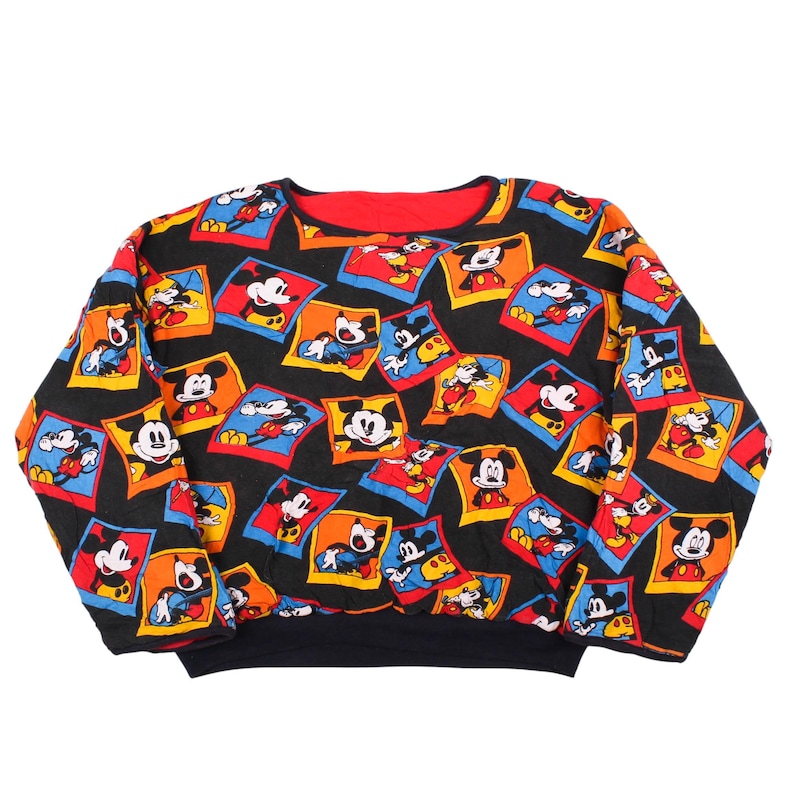 ⁠Vintage 90s Disney Mickey Mouse reversible sweatshirt featuring an all-over print of colorful Mickey cartoon polaroid frames
