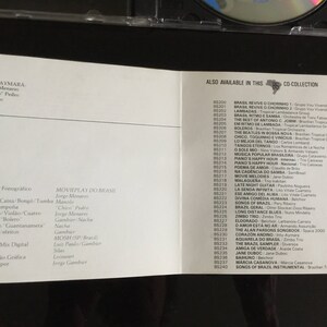 May include: A white CD booklet with text in Portuguese and English. The booklet lists the songs on the CD and the musicians who played on the album. The text on the front of the booklet reads "INTI-AYMARA" and "MOVIEPLAY DO BRASIL".