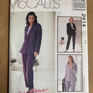 May include: A McCall's sewing pattern featuring a purple suit with a blazer and pants. The pattern includes images of the suit and the text "FOR REAL PEOPLE". The size is 14.