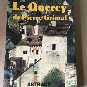 May include: A book cover with a photo of a village in France. The title of the book is "Le Quercy" by Pierre Grimal. The book is published by Arthaud.