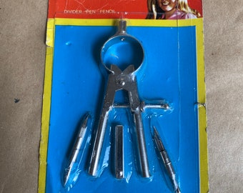 May include: A silver bow compass with a divider, pen, and pencil. The compass is packaged on a blue and yellow card with the text "ARO BOW COMPASS DIVIDER - PEN - PENCIL Style 1531 MADE IN HONG KONG".