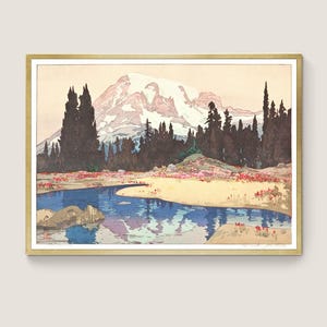 May include: A framed landscape print featuring a mountain with a snow-capped peak, a blue river, and surrounding trees. The artwork has a vintage aesthetic with a gold frame and a serene color palette of blues, greens, and reds.