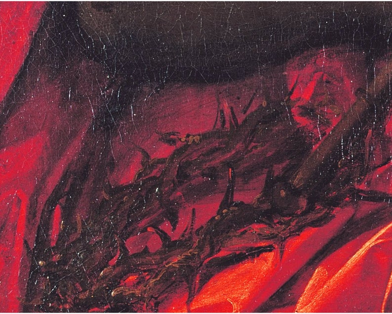 May include: A close-up of a red fabric with a black crown of thorns on top. The fabric is textured and the thorns are painted in a dark brown color.