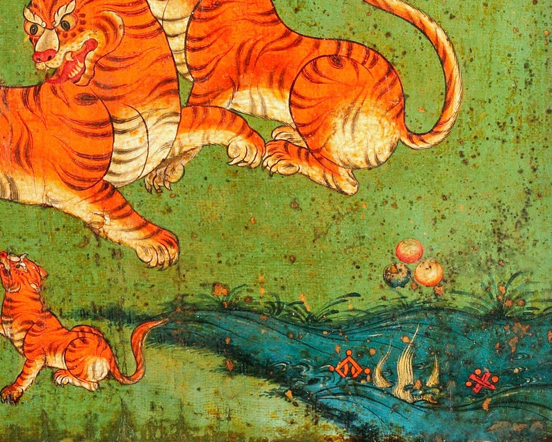 May include: A painting depicting three orange tigers on a green background. The tigers are depicted in a stylised manner, with exaggerated features and bright colours. The painting is likely from a Tibetan or Himalayan tradition.