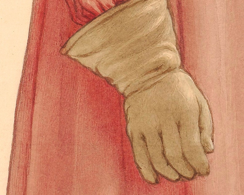 Pu&ograve; includere: Primo piano di un guanto di pelle marrone con una manica di tessuto rosso sotto.