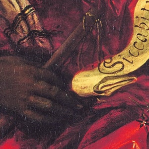 May include: A close-up of a painting depicting a hand holding a scroll with the word "Siccobit" written in gold lettering.