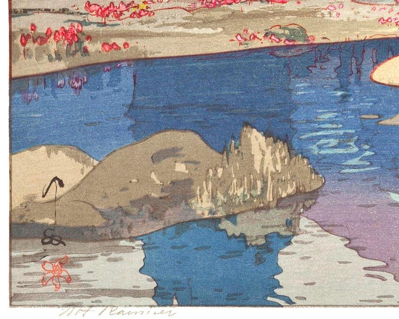 May include: A colorful woodblock print depicting a serene waterscape. The artwork features a blue river reflecting the sky, with a rocky outcrop and a shoreline adorned with pink blossoms. The print has a signature in the bottom right corner.