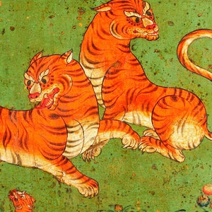 May include: Two orange and black tigers painted on a green background. The tigers are in a dynamic pose, one standing and the other lying down. The painting is done in a traditional style with bold lines and bright colours.