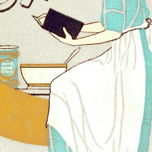 May include: A woman in a turquoise and white dress is reading a book while sitting at a table. A bowl and a can of "Cream of Wheat" are on the table.
