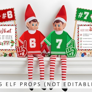 May include: Two elf dolls wearing red and green jerseys with the numbers 6 and 7. Each elf has a matching foam finger and sits next to a sign. The signs read "What Does It Even Mean?!" and list elf-related questions. The text "15 Elf Props (Not Editable)" is at the bottom.