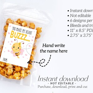 May include: A clear plastic bag filled with popcorn, with a card that says "You make my heart buzz..." and a cartoon bee. The card is designed for a Valentine's Day gift. The card measures 2.75" x 3.75".