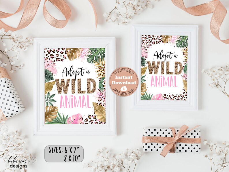 May include: Two printable signs with a jungle theme. The signs are white with a pink and gold leopard print border. The text on the signs reads "Adopt a Wild Animal". The signs are available in two sizes: 5x7 inches and 8x10 inches.