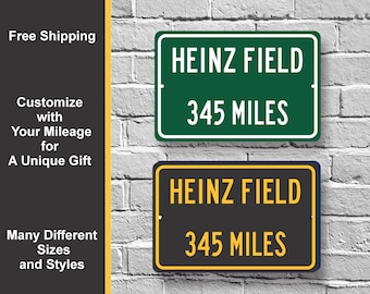 May include: Two signs with the text "HEINZ FIELD 345 MILES" on them. The top sign is green with white text. The bottom sign is black with yellow text.