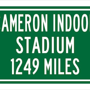 May include: Green road sign with white text that reads "Cameron Indoor Stadium 1249 Miles".