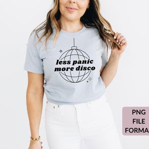 May include: A light blue t-shirt with a black and white graphic of a disco ball and the text "less panic more disco".