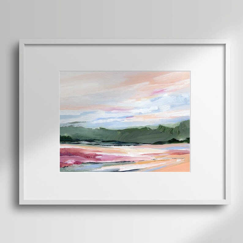May include: A framed abstract painting of a landscape with a pink, green, and blue color scheme. The painting depicts a distant mountain range with a hazy sky above.