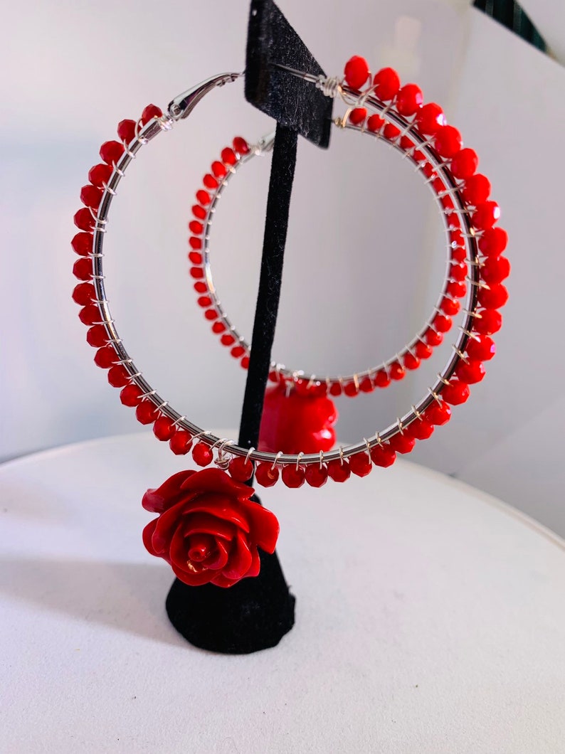 Electric red beads wire wrapped to 2.5 sterling silver lever back hoops with perfectly matched dangling red roses.