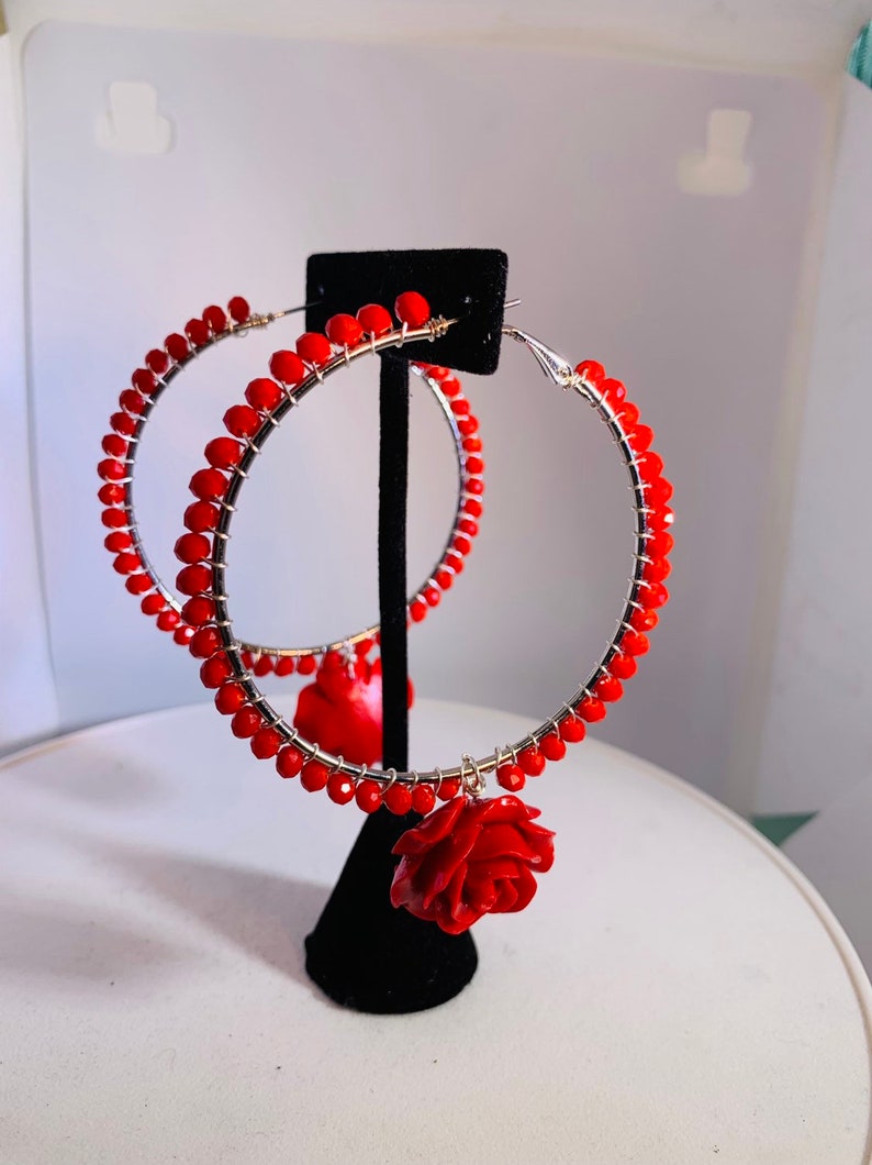 Electric red beads wire wrapped to 2.5 sterling silver lever back hoops with perfectly matched dangling red roses.