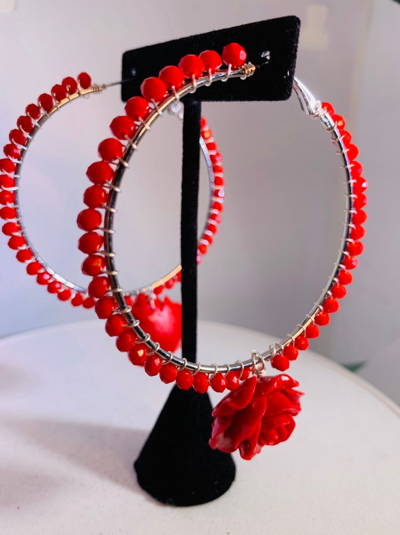 Electric red beads wire wrapped to 2.5 sterling silver lever back hoops with perfectly matched dangling red roses.
