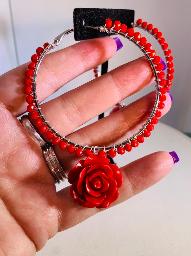 Electric red beads wire wrapped to 2.5 sterling silver lever back hoops with perfectly matched dangling red roses.