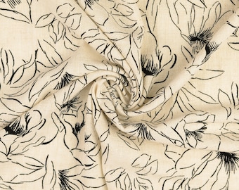 May include: A close-up of a beige fabric with a black floral pattern. The fabric is wrinkled and has a textured surface.