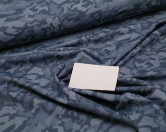 May include: Blue camouflage fabric with a white card on top. The fabric has a subtle textured pattern.