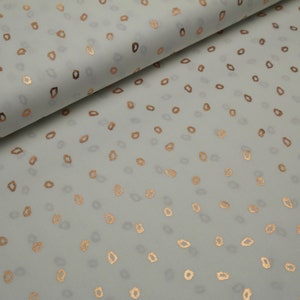 Può includere: Tessuto bianco con un motivo disperso di piccoli ovali dorati.