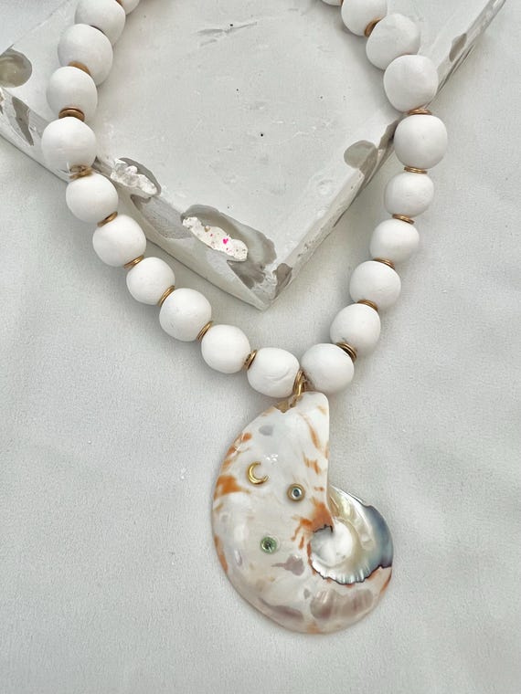 Nautilus shell pendant white clay bead gold necklace