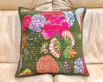 Könnte beinhalten: Quadratisches Zierkissen mit einem Blumenmuster in Rosa, Rot, Gelb und Weiß auf einem dunkelolivgrünen Hintergrund. Das Kissen hat einen dunkelgrünen Rand und weiße Nähte.