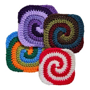 May include: Four crocheted squares with a spiral pattern in different colors, including purple, brown, green, blue, orange, red, and white.