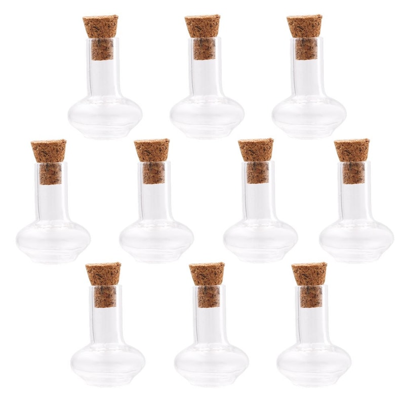 May include: Ten clear glass bottles with cork stoppers. The bottles are round with a narrow neck and a bulbous base.
