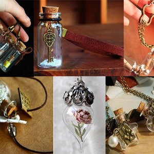 May include: Assortment of glass bottle necklaces with various charms and embellishments. Some bottles contain small objects, such as flowers, keys, and beads. The necklaces are made with different types of chains and cords.
