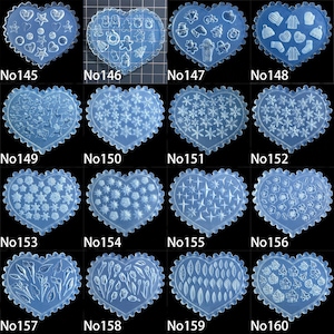 May include: A selection of heart-shaped moulds in translucent blue, featuring diverse designs such as stars, snowflakes, and floral motifs. Each mould has a scalloped edge and is labelled with a number. Measurements are in centimetres.