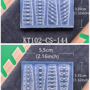 May include: Two clear silicone molds, each with four different designs. The top mold, labeled KT102-CS-144, measures 5.5cm (2.16 inches) wide and 3.35cm (1.32 inches) tall. The bottom mold, labeled KT102-CS-145, has similar dimensions. The molds are on a dark gray surface.